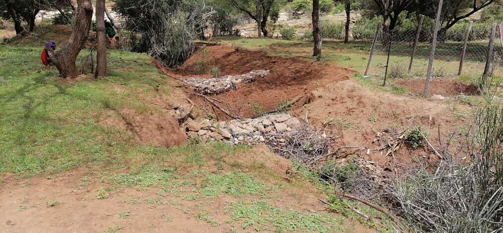Stone check dam built to slow erosion in a gully