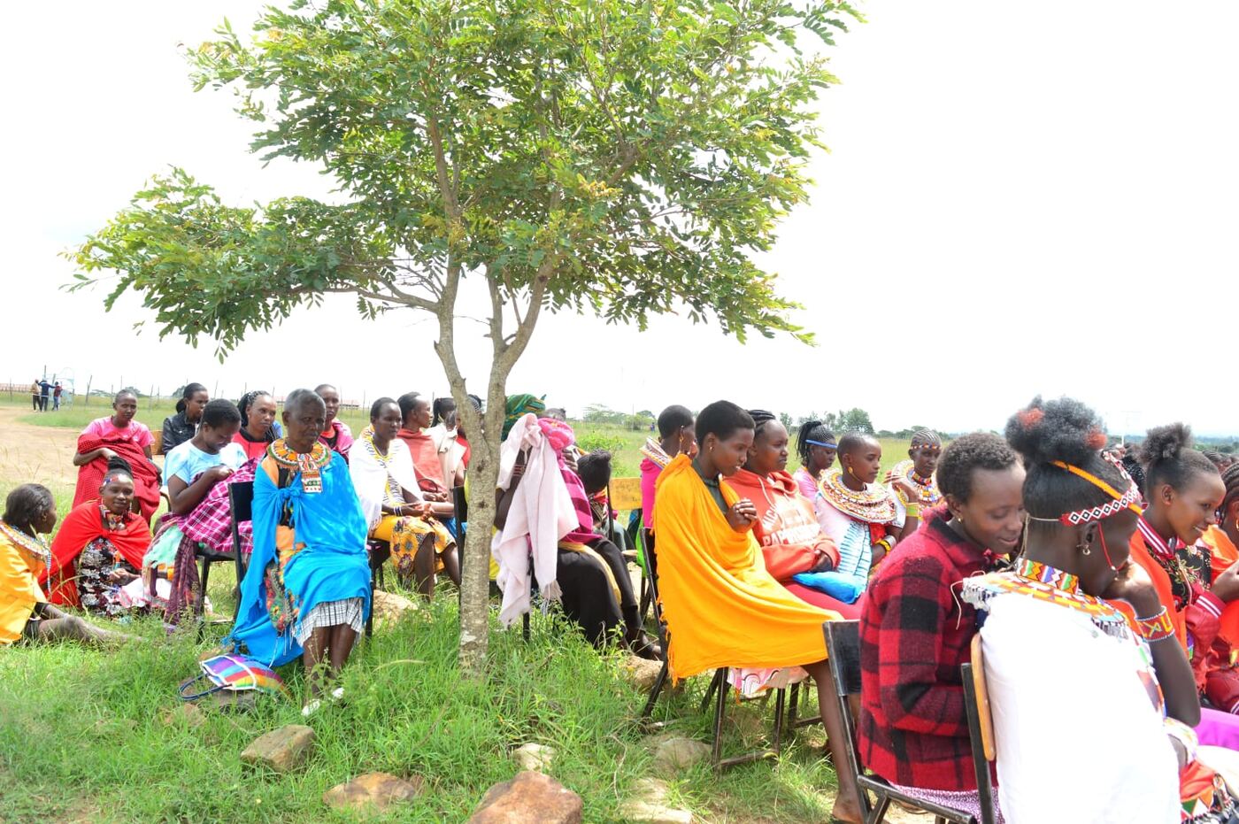 People in traditional dress gathered under a tree at the Menstrual Hygiene Day event, Loosuk, May 2024